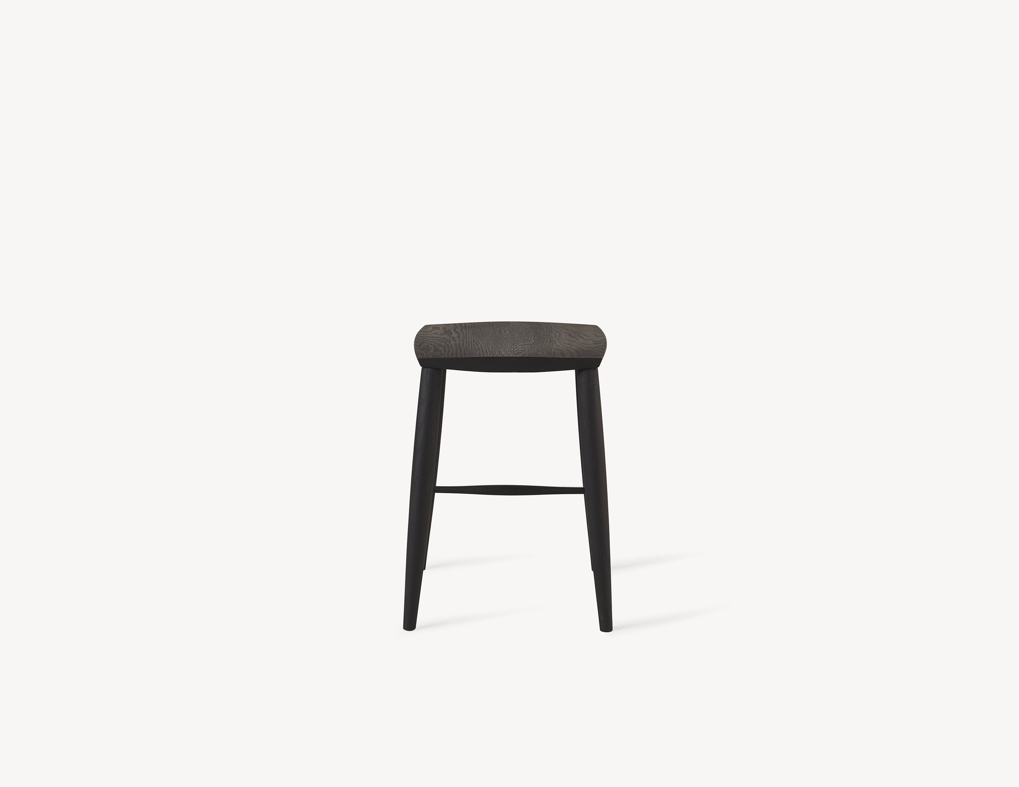 short minimal wooden stool in dark black oak wood.