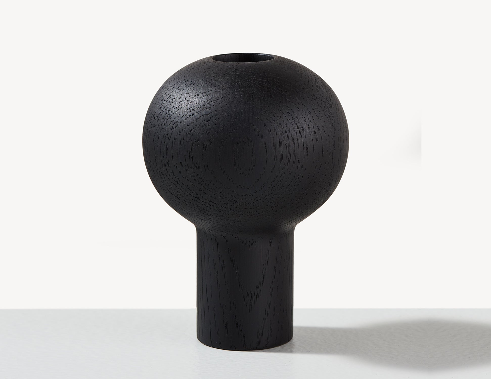 round wooden dry vase in black wood.